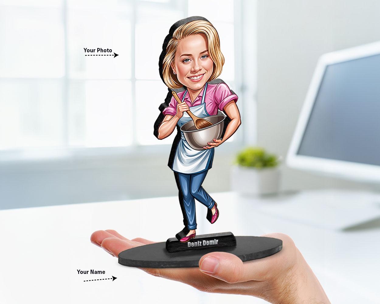 Big-head caricature of a female chef holding a mixing bowl, printed on wood or acrylic with personalized nameplate, white background.