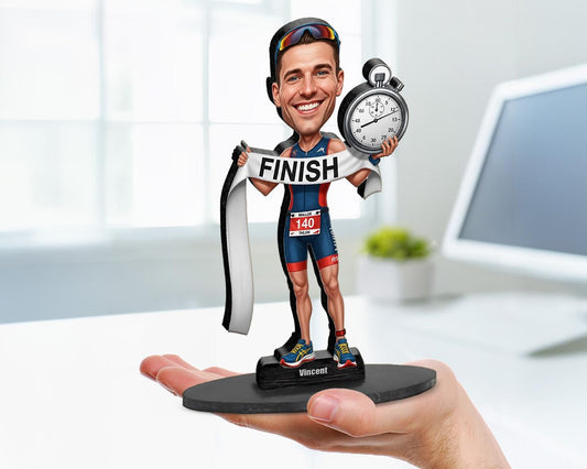 Big-head cartoon caricature of a male triathlete, custom-made from a photo, featuring swim, bike, and run elements, printed on acrylic or mounted on a wooden base.