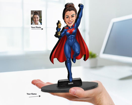 Personalized female superhero caricature figurine with trophy and red cape, custom from user photo. Custom name base. White background.
