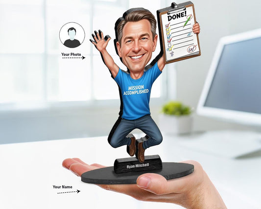 Custom big-head caricature of a man jumping with a clipboard marked “Done!” and wearing a “Mission Accomplished” shirt, printed on wood or acrylic, based on user photo.