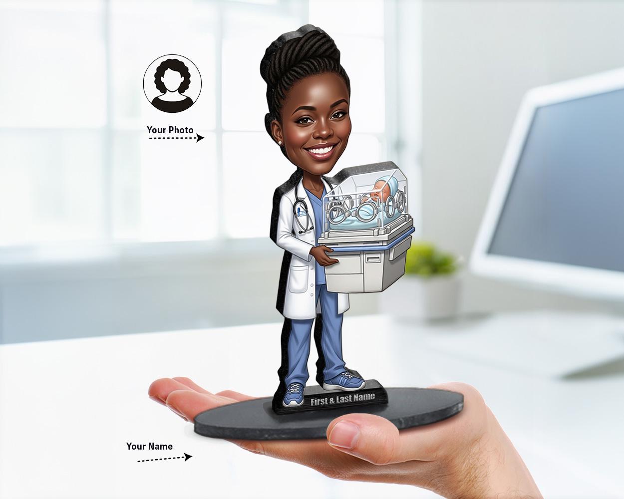 Big-head caricature of a neonatologist or pediatric doctor holding newborn props like incubator, pacifier, or teddy bear, printed on wood or acrylic with a nameplate base, white background.