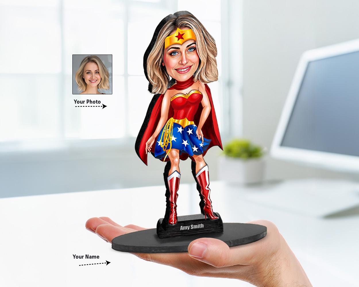 Custom big-head caricature of a woman in superhero costume, printed on wood or acrylic, based on user photo. Standing pose, white background.