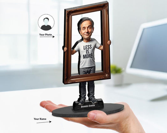 Big-head caricature of a man wearing “Less is More” t-shirt, standing behind a large ornate frame, custom-made from a photo