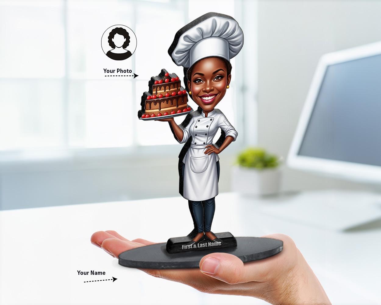 Big-head caricature of a pastry chef holding a decorated cake, printed on wood or acrylic, standing pose, white background.